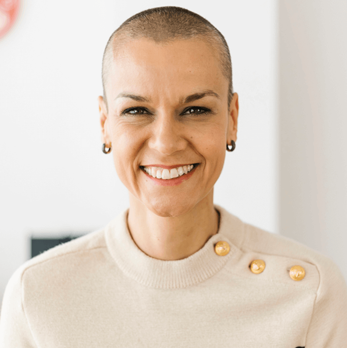 Smiling person with short hair.