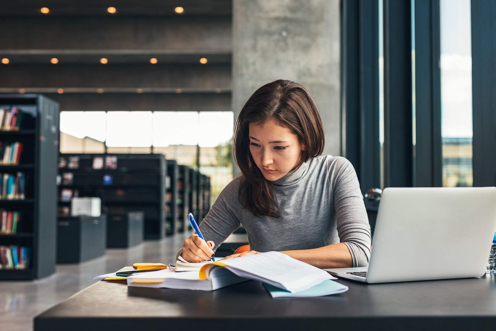 Female White student studying in modern library setting